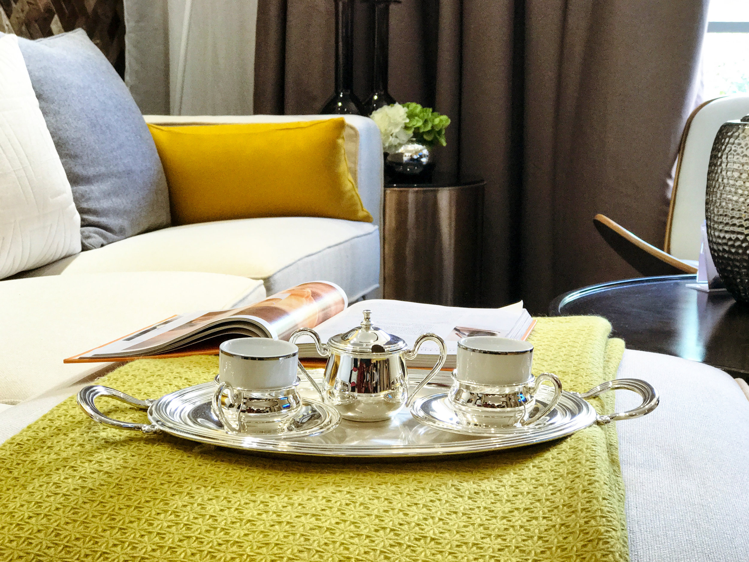 Coffee cups and plates in front of the soft sofa